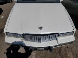 1991 Cadillac Eldorado z VIN 1G6EL13B2MU602660, wystawiony jako Copart lot #67365674 z przebiegiem 108 880 mil mil oraz Szkody całkowita. Historia ofert i sprzedaży dostępna na DreamBid. Obrazek 11.