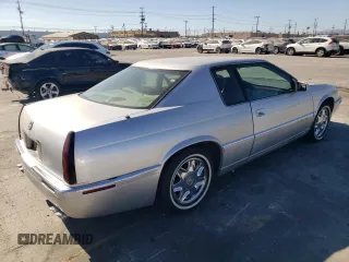 1999 Cadillac Eldorado z VIN 1G6EL12Y0XU604529, wystawiony jako Copart lot #77620004 z przebiegiem 246 032 mil mil oraz Szkoda całkowita • Salvage title. Historia ofert i sprzedaży dostępna na DreamBid. Obrazek 3.
