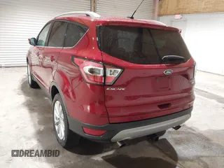 2017 Ford Escape Titanium z VIN 1FMCU9J9XHUC20359, wystawiony jako IAAI lot #41938688 z przebiegiem 79 743 mil mil oraz . Historia ofert i sprzedaży dostępna na DreamBid. Obrazek 3.