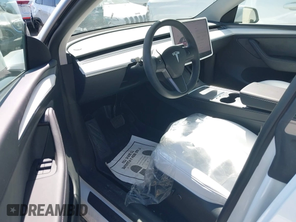 2024 Tesla Model Y with VIN 7SAYGDED2RF017448, listed as a IAAI auction lot 41597056 with 9,702 mi miles and . Bid and sale history available at DreamBid. Image 21.