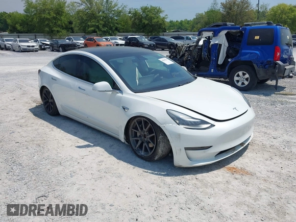 2019 Tesla Model 3 Long Range with VIN 5YJ3E1EB4KF494432, listed as a IAAI auction lot 42009327 with 121,954 mi miles and . Bid and sale history available at DreamBid. Image 1.