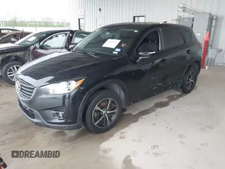 2016 Mazda CX-5 Touring with VIN JM3KE2CY2G0808424, listed as a IAAI auction lot 41880494 with 149,005 mi miles. Bid and sale history available at carsss.com. Image 18.