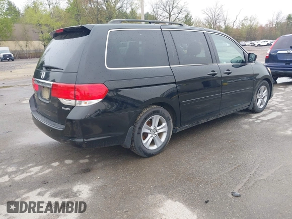2010 Honda Odyssey Touring with VIN 5FNRL3H97AB056975, listed as a IAAI auction lot 42169269 with 183,483 mi miles. Bid and sale history available at carsss.com. Image 4.
