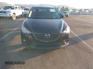 2016 Mazda CX-5 Touring with VIN JM3KE2CY5G0704574, listed as a IAAI auction lot 41033546 with 133,502 mi miles. Bid and sale history available at carsss.com. Image 6.