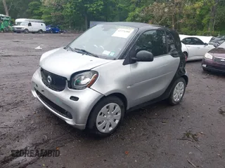 2016 Smart fortwo Passion z VIN WMEFJ5DA3GK055906, wystawiony jako IAAI lot #42274280 z przebiegiem 29 070 mil mil oraz . Historia ofert i sprzedaży dostępna na DreamBid. Obrazek 2.