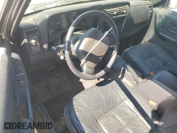 1999 Jeep Cherokee Sport z VIN 1J4FF68S3XL597049, wystawiony jako Copart lot #58736325 z przebiegiem 134 684 mil mil oraz Nie do naprawy • Non repairable. Historia ofert i sprzedaży dostępna na DreamBid. Obrazek 8.