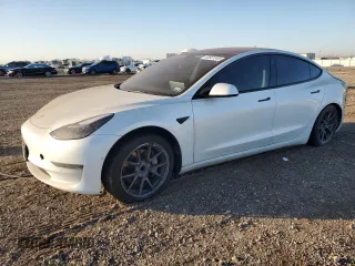 2021 Tesla Model 3 Standard Range Plus with VIN 5YJ3E1EA9MF100403, listed as a Copart auction lot 48561545 with 68,996 mi miles and Salvage Title. Bid and sale history available at carsss.com. Image 1.