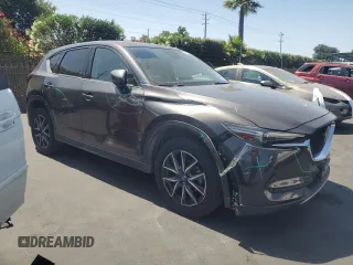 2018 Mazda CX-5 Grand Touring with VIN JM3KFADM3J1389911, listed as a Copart auction lot 60530295 with 103,177 mi miles and Salvage title. Bid and sale history available at DreamBid. Image 4.