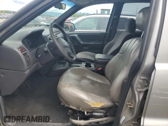 2000 Jeep Grand Cherokee Laredo with VIN 1J4GW48S9YC390448, listed as a Copart auction lot 56985265 with Not provided miles and Salvage title. Bid and sale history available at DreamBid. Image 7.