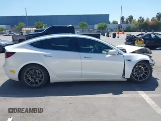 2020 Tesla Model 3 Standard Range Plus with VIN 5YJ3E1EAXLF590591, listed as a IAAI auction lot 42140338 with 79,342 mi miles and . Bid and sale history available at DreamBid. Image 14.
