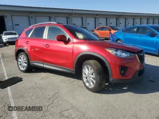 2014 Mazda CX-5 Grand Touring with VIN JM3KE4DY9E0419111, listed as a Copart auction lot 52250315 with 130,003 mi miles and Salvage Title. Bid and sale history available at DreamBid. Image 4.