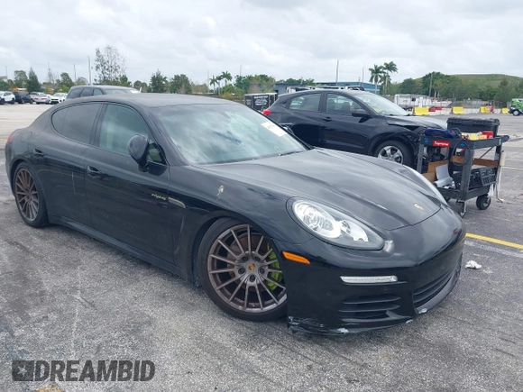 2015 Porsche Panamera S E-Hybrid z VIN WP0AD2A72FL040703, wystawiony jako IAAI lot #41937431 z przebiegiem 77 933 mil mil oraz . Historia ofert i sprzedaży dostępna na DreamBid. Obrazek 1.