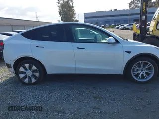 2024 Tesla Model Y with VIN 7SAYGDED2RF017448, listed as a IAAI auction lot 41597056 with 9,702 mi miles and . Bid and sale history available at DreamBid. Image 13.