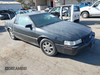 2001 Cadillac Eldorado Touring ETC z VIN 1G6ET12911B103774, wystawiony jako IAAI lot #41998828 z przebiegiem 128 724 mil mil oraz . Historia ofert i sprzedaży dostępna na DreamBid. Obrazek 1.