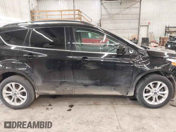 2018 Ford Escape SE z VIN 1FMCU9GD0JUC25636, wystawiony jako IAAI lot #40996760 z przebiegiem 70 097 mil mil oraz . Historia ofert i sprzedaży dostępna na DreamBid. Obrazek 14.
