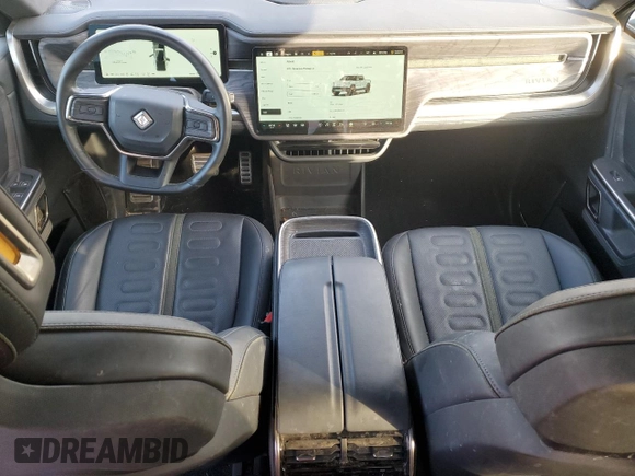 2023 Rivian R1T Adventure with VIN 7FCTGAAA2PN017170, listed as a Copart auction lot 77473014 with 28,821 mi miles and Salvage Title. Bid and sale history available at DreamBid. Image 8.