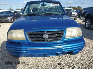 2001 Suzuki Vitara JLS z VIN 2S3TC52C116101163, wystawiony jako Copart lot #74469744 z przebiegiem Nie podano mil oraz Szkody całkowita. Historia ofert i sprzedaży dostępna na DreamBid. Obrazek 5.