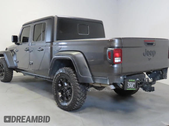 2023 Jeep Gladiator Freedom with VIN 1C6JJTAG9PL557861, listed as a Copart auction lot 56429485 with 44,716 mi miles and Salvage title. Bid and sale history available at DreamBid. Image 4.