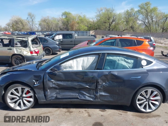 2018 Tesla Model 3 Long Range Battery with VIN 5YJ3E1EBXJF055203, listed as a IAAI auction lot 42019770 with 57,379 mi miles and . Bid and sale history available at DreamBid. Image 14.