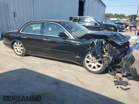 2004 Jaguar XJ with VIN SAJEA71C74SG02851, listed as a Copart auction lot 69056994 with 0 mi miles and Salvage Title. Bid and sale history available at carsss.com. Image 3.