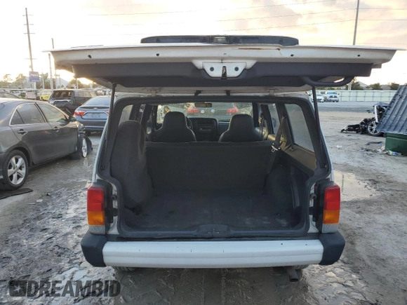 1999 Jeep Cherokee Sport with VIN 1J4FT68S6XL578679, listed as a Copart auction lot 76697394 with 196,110 mi miles and Salvage title. Bid and sale history available at DreamBid. Image 6.