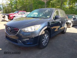 2016 Mazda CX-5 Sport with VIN JM3KE2BY3G0657904, listed as a IAAI auction lot 42127897 with 153,855 mi miles. Bid and sale history available at carsss.com. Image 2.