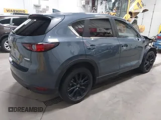 2021 Mazda CX-5 Touring z VIN JM3KFBCM4M0459465, wystawiony jako IAAI lot #41059836 z przebiegiem 74 645 mil mil oraz . Historia ofert i sprzedaży dostępna na DreamBid. Obrazek 4.