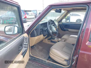 2000 Jeep Cherokee Classic with VIN 1J4FF58S7YL122676, listed as a IAAI auction lot 41710310 with 124,758 mi miles. Bid and sale history available at carsss.com. Image 5.