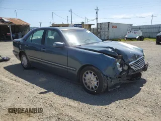 2000 Mercedes-Benz E-Class with VIN WDBJF65J1YB151080, listed as a Copart auction lot 54421955 with 392,612 mi miles and Salvage Title. Bid and sale history available at carsss.com. Image 4.