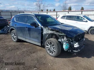 2019 Mazda CX-5 Signature with VIN JM3KFBEY5K0609063, listed as a IAAI auction lot 41802772 with 104,112 mi miles. Bid and sale history available at carsss.com. Image 1.