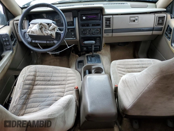 1995 Jeep Grand Cherokee Laredo with VIN 1J4FX58S8SC773884, listed as a Copart auction lot 56572555 with 424,126 mi miles and Salvage title. Bid and sale history available at DreamBid. Image 8.