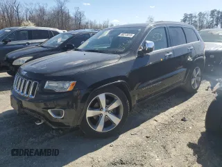 2014 Jeep Grand Cherokee Overland with VIN 1C4RJFCG1EC587458, listed as a Copart auction lot 50213015 with 124,266 mi miles and Salvage Title. Bid and sale history available at carsss.com. Image 1.