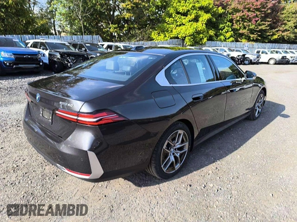 2024 BMW i5 eDrive40 with VIN WBY33FK05RCR58520, listed as a Copart auction lot 77179704 with 16 mi miles and Salvage Title. Bid and sale history available at carsss.com. Image 4.