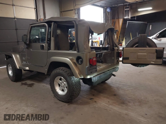 2004 Jeep Wrangler Sahara with VIN 1J4FA59S64P736389, listed as a IAAI auction lot 41432819 with 102,830 mi miles and . Bid and sale history available at DreamBid. Image 3.