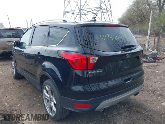2019 Ford Escape Titanium with VIN 1FMCU9J91KUC42161, listed as a IAAI auction lot 41942122 with 100,677 mi miles and . Bid and sale history available at DreamBid. Image 3.
