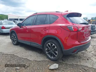 2016 Mazda CX-5 Grand Touring z VIN JM3KE2DY6G0693678, wystawiony jako IAAI lot #42443247 z przebiegiem 127 620 mil mil oraz . Historia ofert i sprzedaży dostępna na DreamBid. Obrazek 3.