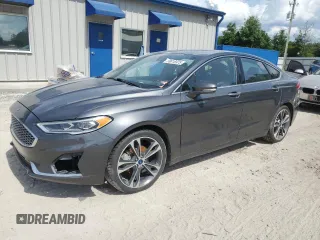 2020 Ford Fusion Titanium z VIN 3FA6P0K97LR137562, wystawiony jako Copart lot #58816975 z przebiegiem 127 455 mil mil oraz Czysty tytuł • Clean title. Historia ofert i sprzedaży dostępna na DreamBid. Obrazek 1.
