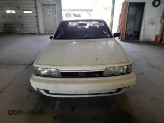1991 Toyota Camry z VIN 4T1VV21E8MU050409, wystawiony jako Copart lot #61379824 z przebiegiem 100 949 mil mil oraz Nie do naprawy • Non repairable. Historia ofert i sprzedaży dostępna na DreamBid. Obrazek 5.