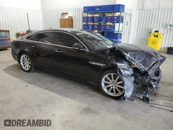 2014 Jaguar XJ with VIN SAJWA1CZ0E8V61168, listed as a Copart auction lot 54383215 with 137,724 mi miles and Salvage Title. Bid and sale history available at DreamBid. Image 4.