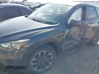 2016 Mazda CX-5 Grand Touring with VIN JM3KE4DY8G0823567, listed as a IAAI auction lot 41784384 with 143,836 mi miles and . Bid and sale history available at carsss.com. Image 6.