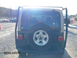 2000 Jeep Wrangler Sahara with VIN 1J4FA59S0YP724521, listed as a IAAI auction lot 41574689 with 167,584 mi miles. Bid and sale history available at carsss.com. Image 16.