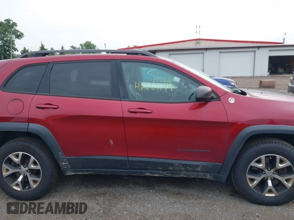 2015 Jeep Cherokee Trailhawk with VIN 1C4PJMBS6FW575517, listed as a IAAI auction lot 42661199 with 299,166 mi miles and . Bid and sale history available at DreamBid. Image 13.