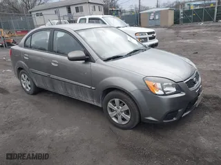 2011 Kia Rio LX with VIN KNADH4A34B6940793, listed as a IAAI auction lot 41623885 with 114,748 mi miles. Bid and sale history available at carsss.com. Image 1.