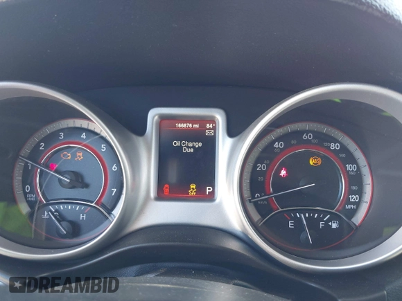 2015 Dodge Journey SE z VIN 3C4PDCAB5FT679585, wystawiony jako IAAI lot #42090600 z przebiegiem 166 876 mil mil oraz . Historia ofert i sprzedaży dostępna na DreamBid. Obrazek 7.