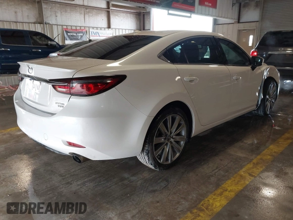 2021 Mazda 6 Carbon Edition with VIN JM1GL1WY9M1614117, listed as a IAAI auction lot 41305576 with 54,670 mi miles and . Bid and sale history available at DreamBid. Image 4.