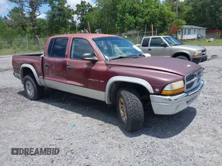 2001 Dodge Dakota Sport z VIN 1B7GG2AN91S168614, wystawiony jako IAAI lot #42692637 z przebiegiem 145 204 mil mil oraz . Historia ofert i sprzedaży dostępna na DreamBid. Obrazek 1.