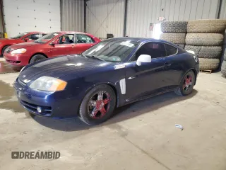 2003 Hyundai Tiburon GT z VIN KMHHN65F43U075197, wystawiony jako Copart lot #52617655 z przebiegiem 117 561 mil mil oraz Szkoda całkowita • Salvage title. Historia ofert i sprzedaży dostępna na DreamBid. Obrazek 1.