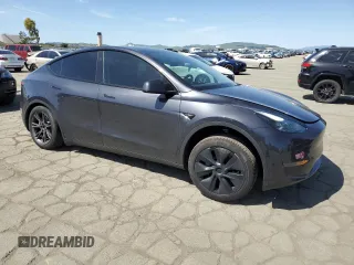 2025 Tesla Model Y Long Range with VIN 7SAYGDED4SF240354, listed as a Copart auction lot 52049745 with 6,785 mi miles and Salvage Title. Bid and sale history available at DreamBid. Image 4.