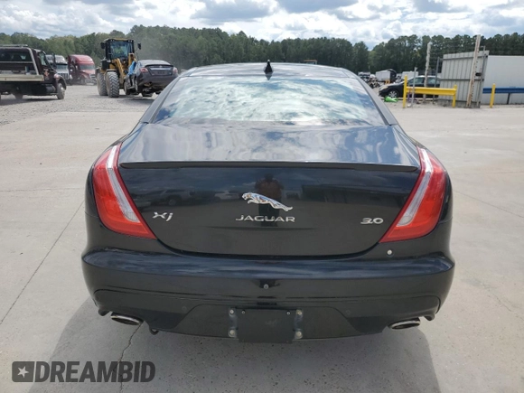 2018 Jaguar XJ with VIN SAJWA1C76J8W14271, listed as a Copart auction lot 73777914 with 124,155 mi miles and Salvage Title. Bid and sale history available at carsss.com. Image 6.