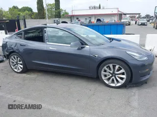 2018 Tesla Model 3 Long Range Battery with VIN 5YJ3E1EA8JF059385, listed as a IAAI auction lot 42116589 with 63,630 mi miles and . Bid and sale history available at DreamBid. Image 14.